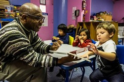 Librarian Colbert Nembhard with Homeless Children of Shelters, Photo Courtesy of the New York Times